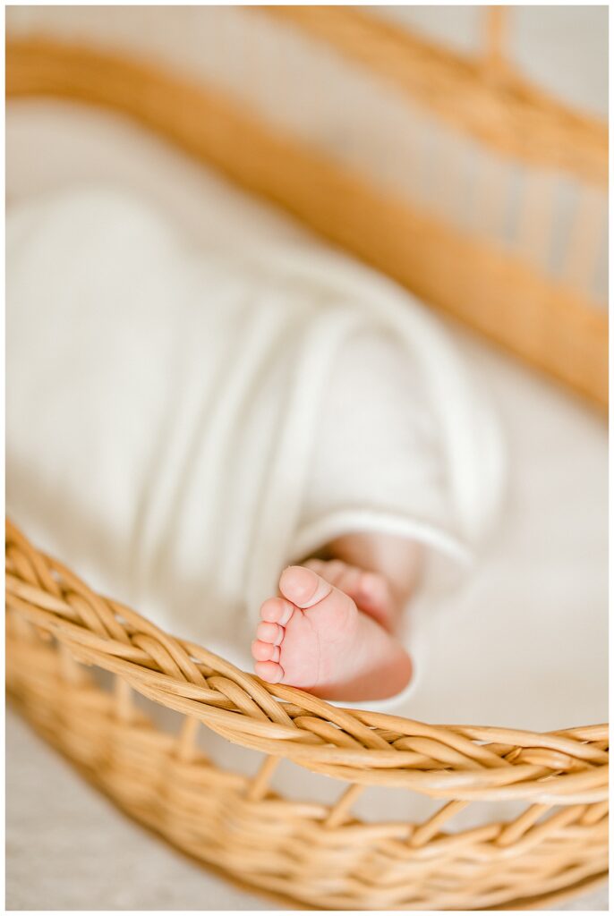 Newborn boy posed in basket with soft textures Indianapolis newborn photographer