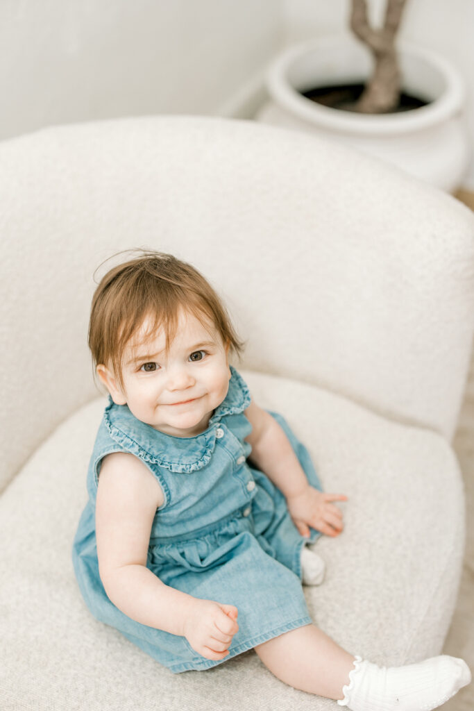Baby Darcy celebrating her first birthday during milestone session