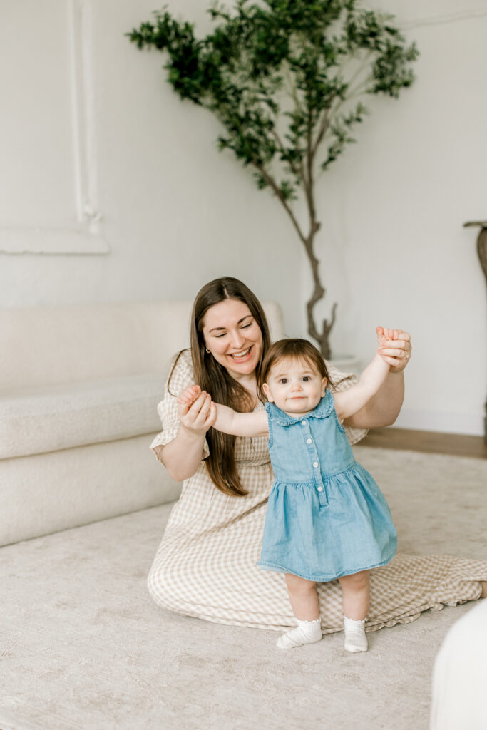 Candid moment of one year old interacting with parents during session