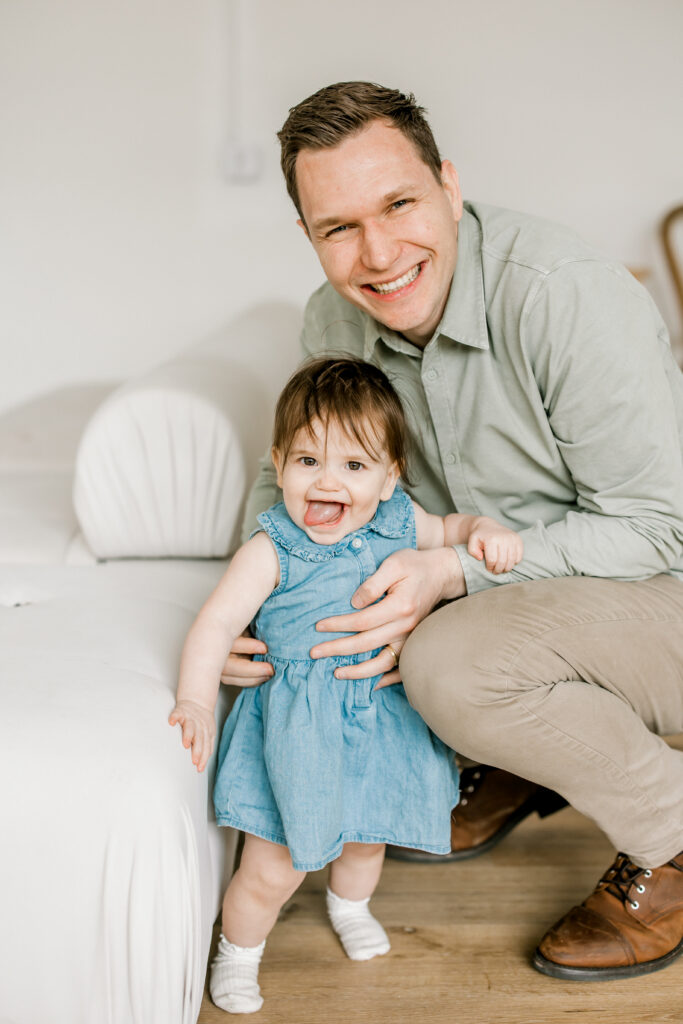 miling one year old baby girl showing personality during milestone photos
