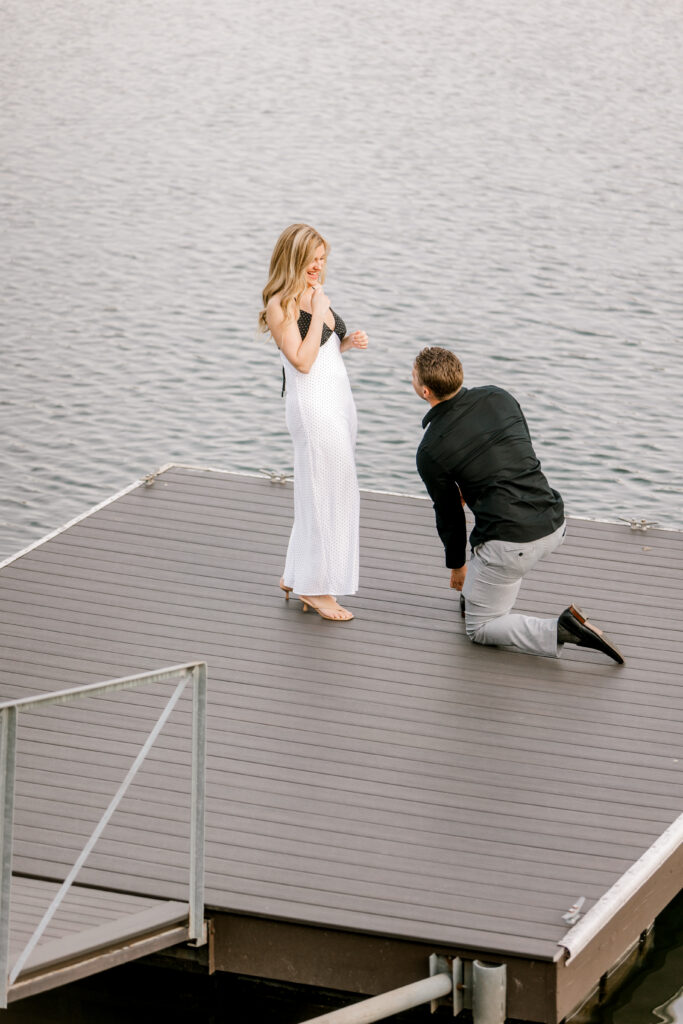 Emotional reaction during lakeside proposal in Fishers IN with couple embracing after she said yes
