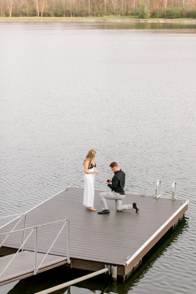 Man proposing to girlfriend at a lake house in Fishers Indiana during a surprise engagement