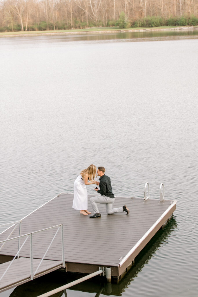 Man proposing to girlfriend at a lake house in Fishers Indiana during a surprise engagement