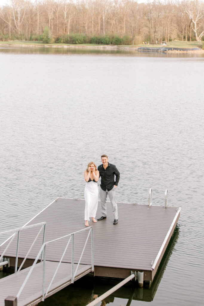 Emotional reaction during lakeside proposal in Fishers IN with couple embracing after she said yes