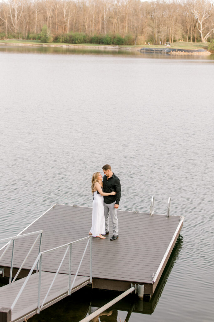 Engaged couple hugging and smiling after romantic proposal in Fishers Indiana