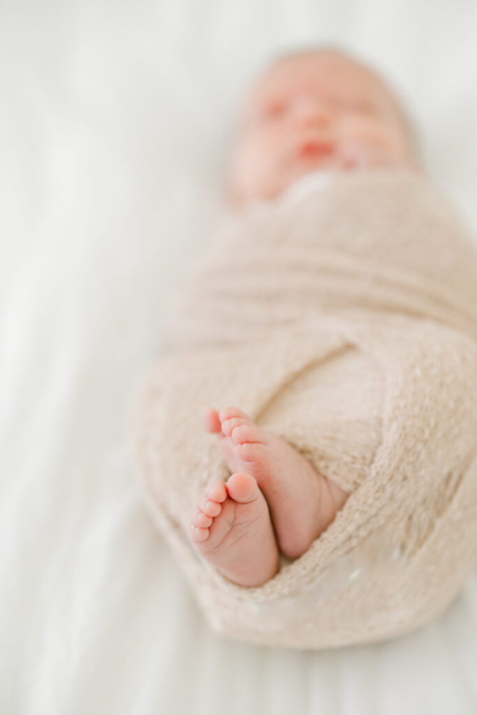 Close-up of newborn Baby Beau’s tiny hands and toes in studio photography session