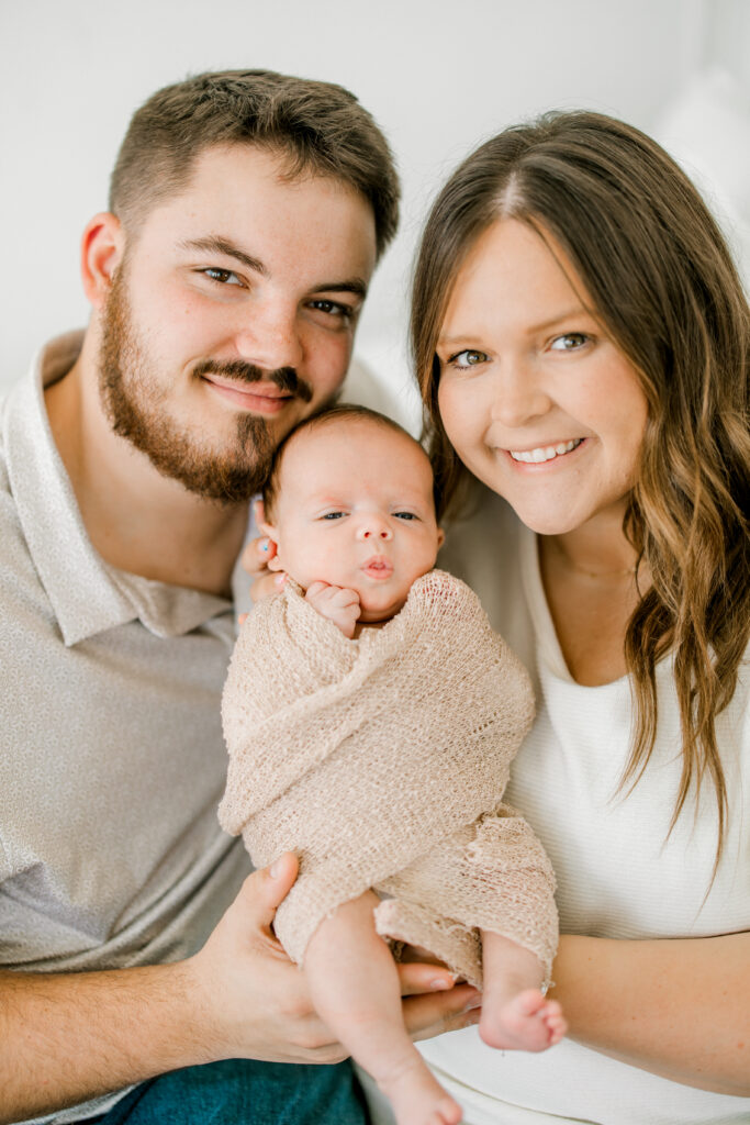 Parents Jordyn and Noah holding newborn Baby Beau during studio session in downtown Indianapolis