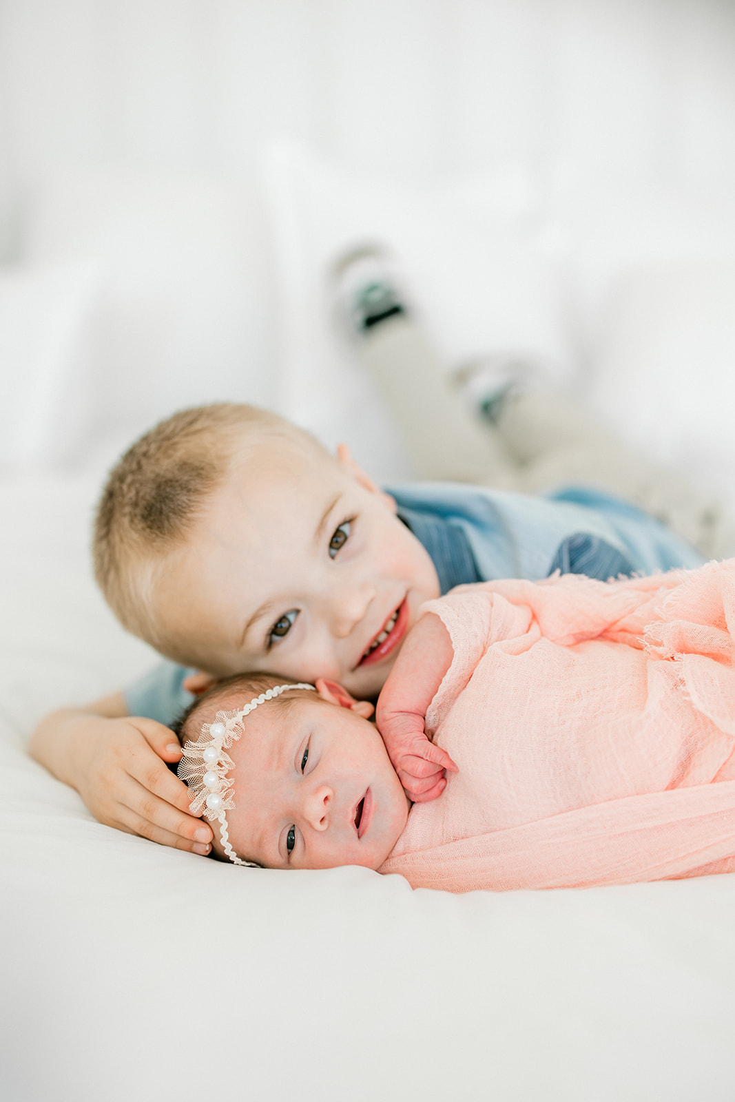 Sibling photo with toddler boy and newborn baby girl in studio Indianapolis